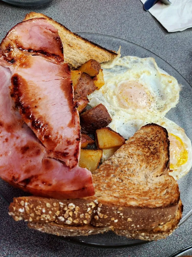 Ham Steak with Eggs over Medium with Well Done Home Fries and Whole Wheat Toast